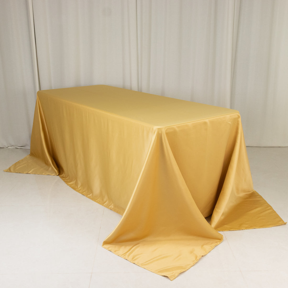 Gold satin tablecloth draped elegantly over a table