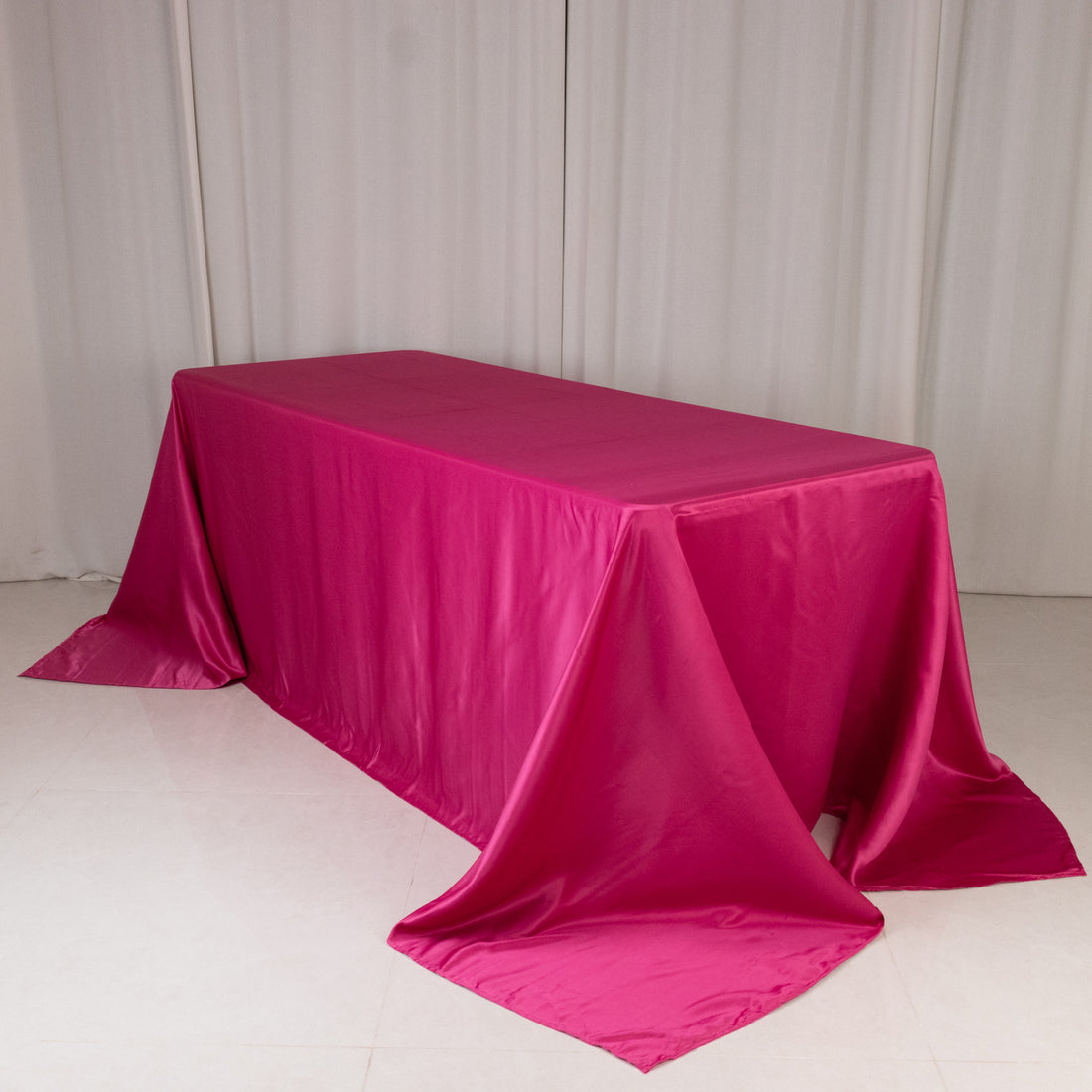 Pink satin tablecloth draped elegantly over a table.