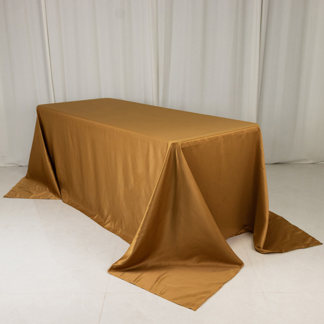 Gold satin tablecloth draped elegantly over a table
