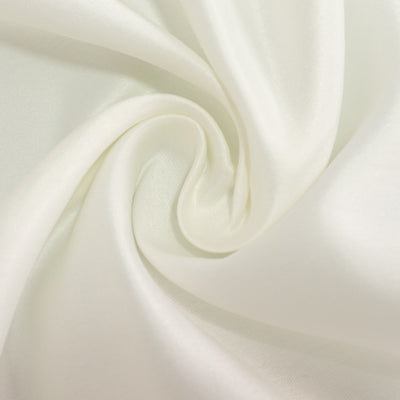 Soft white fabric swirl texture close-up.