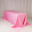 Pink tablecloth draped elegantly over a table in a studio setting.