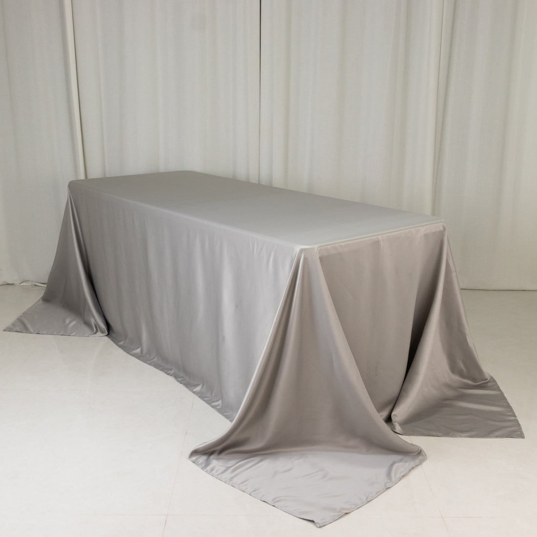 Gray tablecloth draped elegantly over a table in a studio setting.