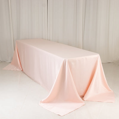 Pink satin tablecloth on a plain backdrop.