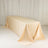 Beige satin tablecloth draped over a table in a studio setting.