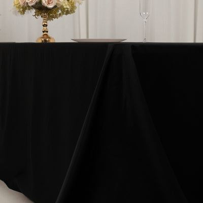 Elegant black tablecloth draping over a table in a styled setting.