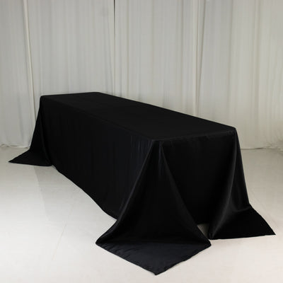Black tablecloth draped elegantly over a rectangular table.