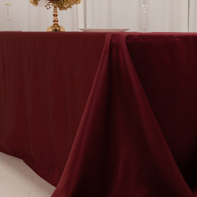 Burgundy tablecloth draped elegantly over a table in a styled setting.