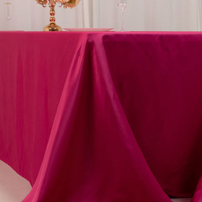 Fuchsia tablecloth draped elegantly over a dining table.