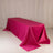 Pink tablecloth draped over a long table in a studio setting.