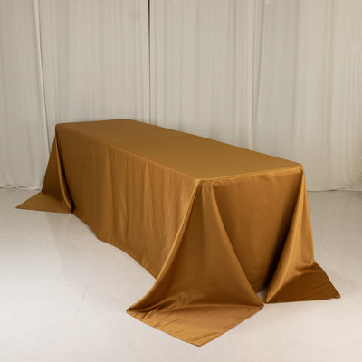 Gold tablecloth draped elegantly over a table in a studio setting.