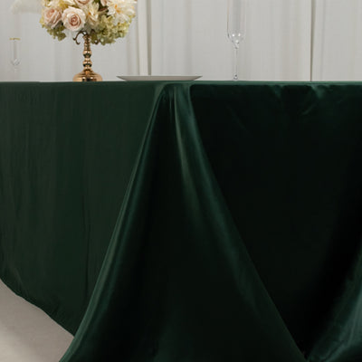 Green satin tablecloth draped elegantly over a table.