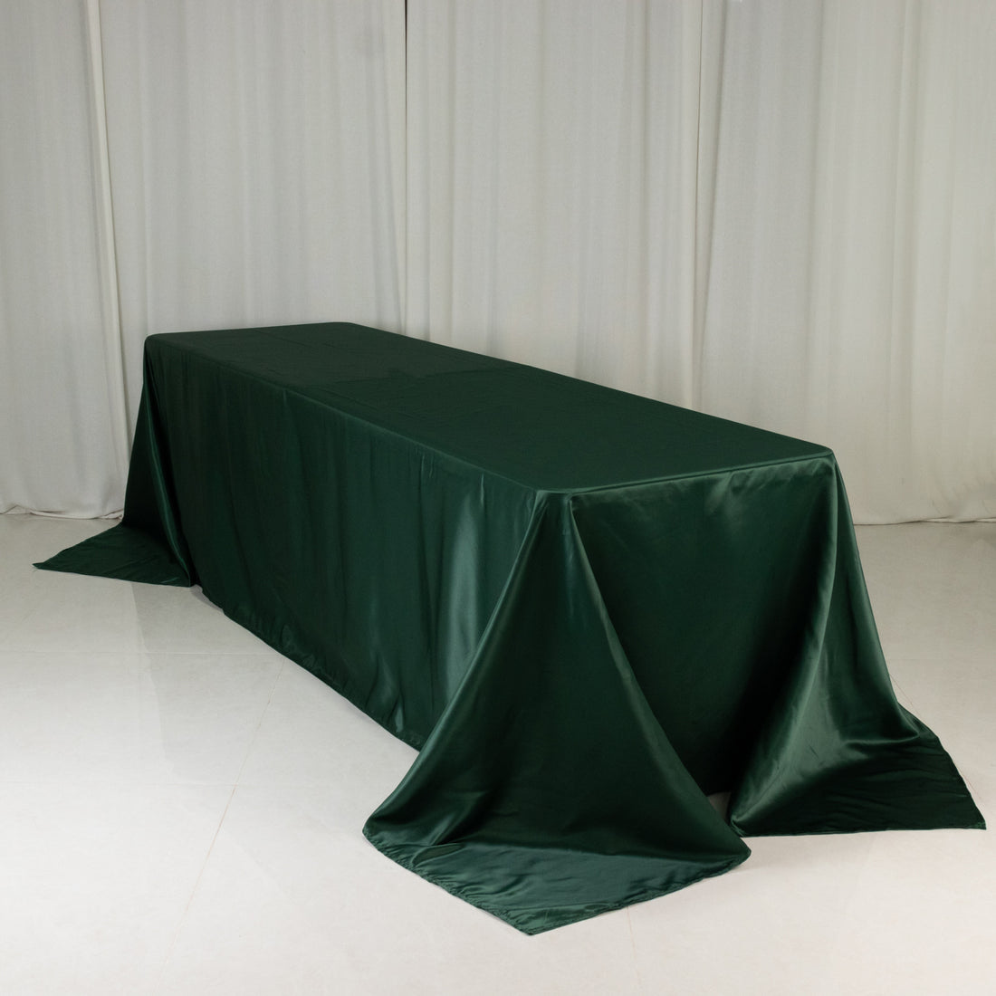 Green tablecloth draped over a table in a studio setting.