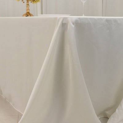 Elegant white tablecloth draping over a table with decorative elements.