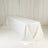 White table with draped tablecloth in a studio setting