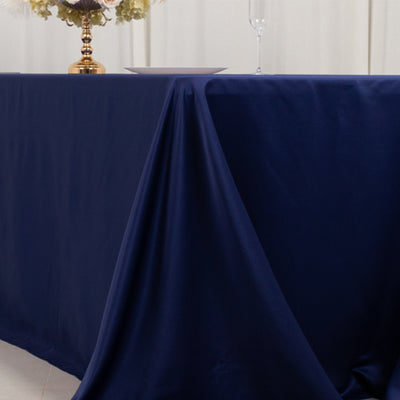Navy tablecloth draping elegantly over a table in a styled setting.