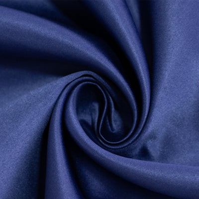 Navy blue satin fabric swirl texture close-up shot.