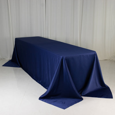 Navy tablecloth draped over a rectangular table in studio setting.