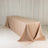 Rectangular beige tablecloth draped over a long table in a studio setting.