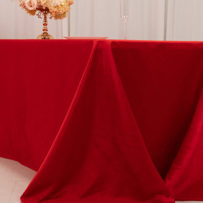 Red tablecloth draped elegantly over a table in a styled setting.