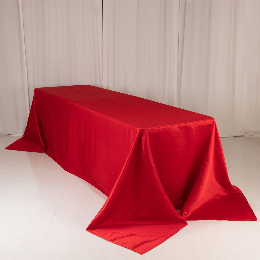 Red tablecloth draped elegantly over a table in a studio setting.