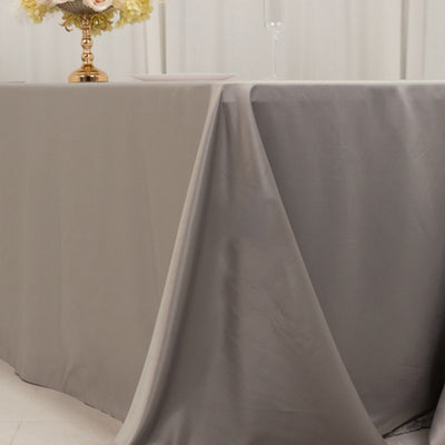 Elegant tablecloths in gray and beige draped over tables