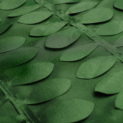 Green leaf-patterned fabric close-up texture shot.
