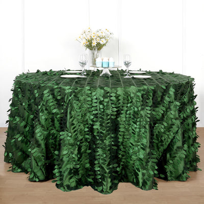 Green leaf-patterned tablecloth on a round table with decorative items.