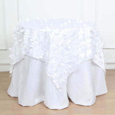White tablecloth with textured leaf design draped over a round table