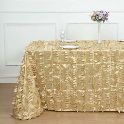 Elegant gold tablecloth draped with leaf accents, styled for an event setting.