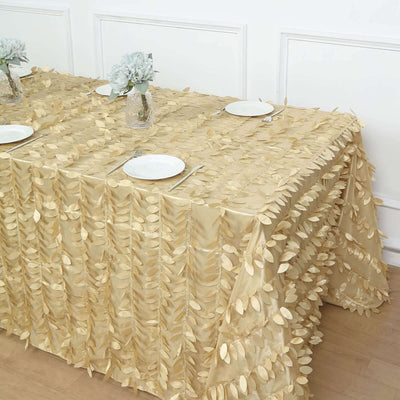 Gold leaf tablecloth draping elegantly over a table set with plates and floral centerpieces.