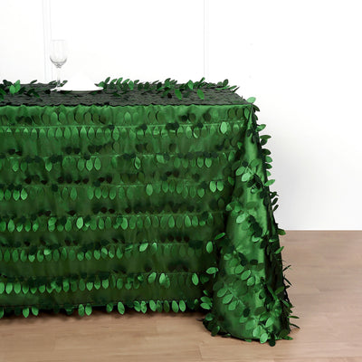 Green leaf-patterned tablecloth on a table.