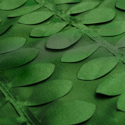 Green leaf-patterned fabric close-up showcasing texture and design details. #whtbkgd