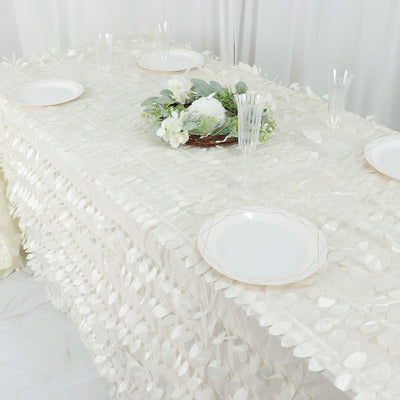 Elegant white table setting with decorative plates and floral centerpiece.