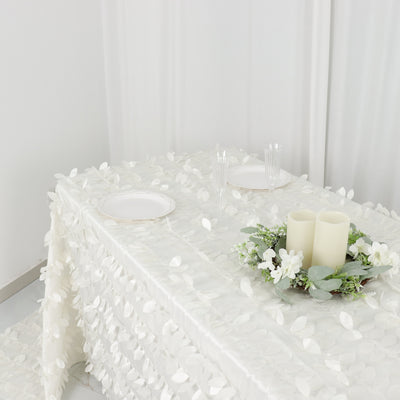 Elegant table setting with floral tablecloth, candles, and glassware.