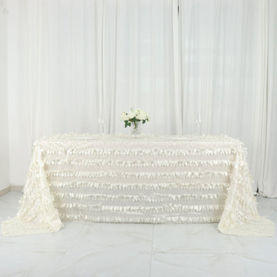 White textured tablecloth draped on a table with floral centerpiece.