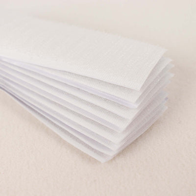 Stack of white fabric sheets for crafting and sewing projects