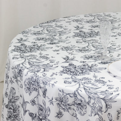 Floral-patterned round tablecloth on a dining table.