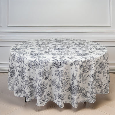 Round floral tablecloth with intricate black and white design.