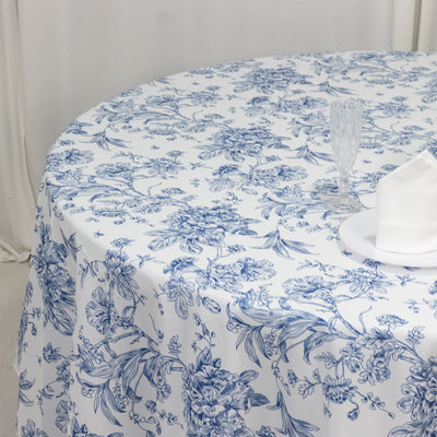 Blue floral patterned round tablecloth on a dining table.