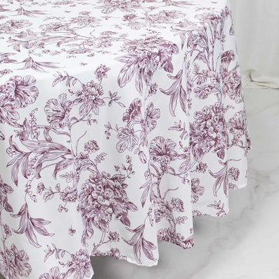 Floral botanical patterned bedspread in white and mauve on a bed
