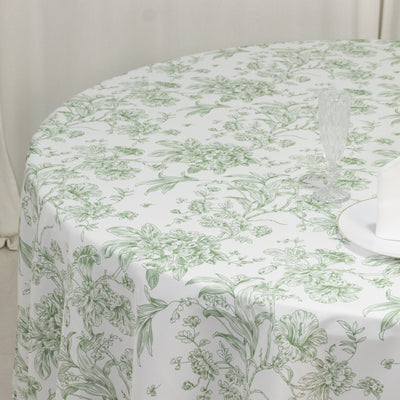 Round floral tablecloth with green botanical design on white background.