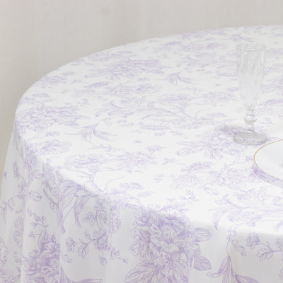 Floral patterned tablecloth on a round table with a glass and plate