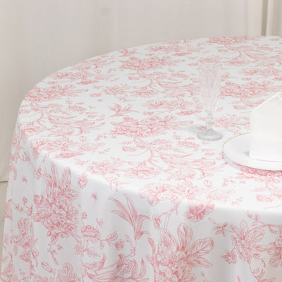 Floral patterned tablecloth on a round table with glassware.