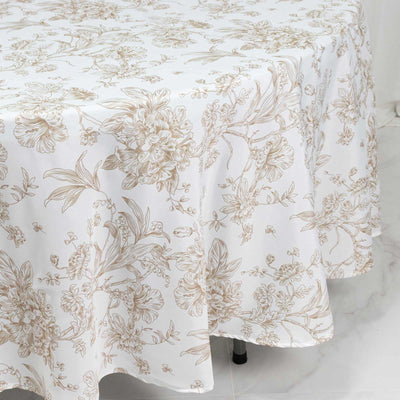 White floral tablecloth with gold botanical print on dining table