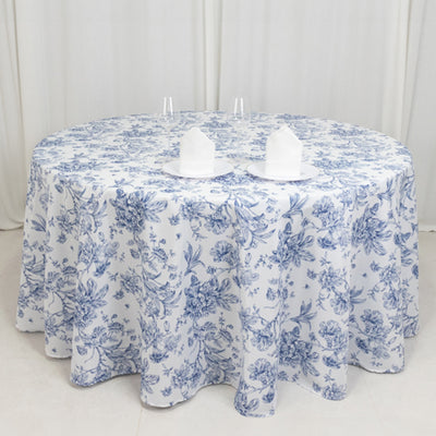 Blue floral round tablecloth with white napkins on a table.