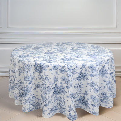 Floral print round tablecloth in blue and white on a plain background.