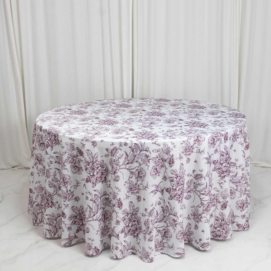 Round floral tablecloth in white and mauve with draped skirt design