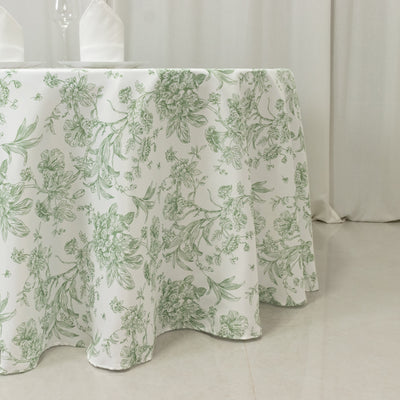 Floral patterned tablecloth draping over a table in a neutral setting.