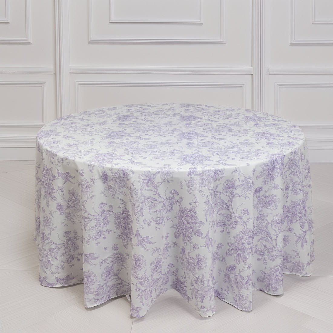 Round floral tablecloth in lavender and white with elegant design.