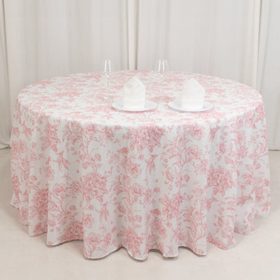 Round floral tablecloth in soft pink and white on a table with napkins.